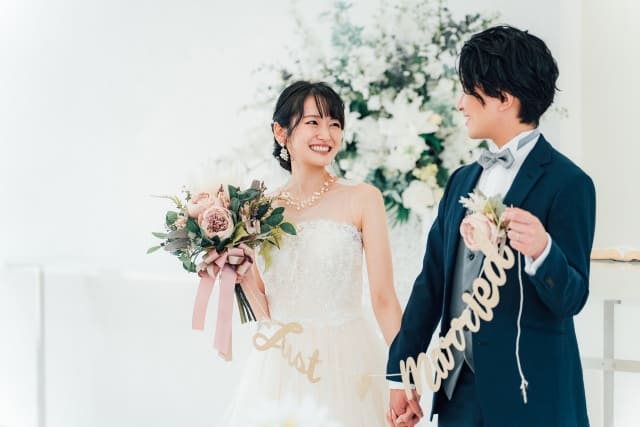 岡崎結婚相談所ハピマリで岡崎市で婚活していた婚活女性と婚活男性が仲良く結婚式場で結婚して微笑むイメージ画像